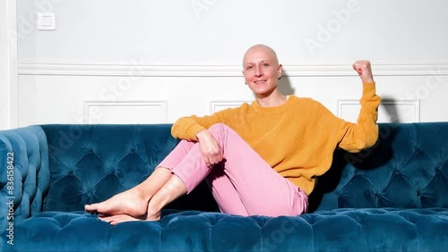 Smiling bald woman relaxing celebrating victory over cancer