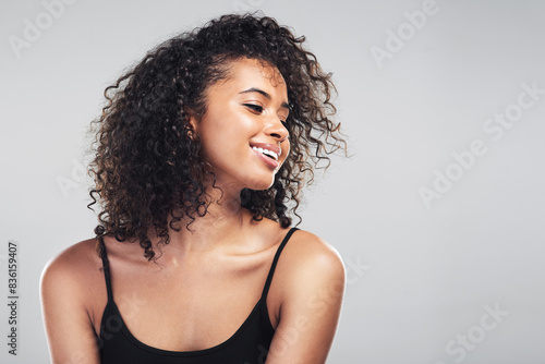 Studio, woman and beauty for curly hair and natural, happy and cosmetic on white background. Haircare, cosmetology or keratin treatment for texture for model person, healthy and growth with shine photo
