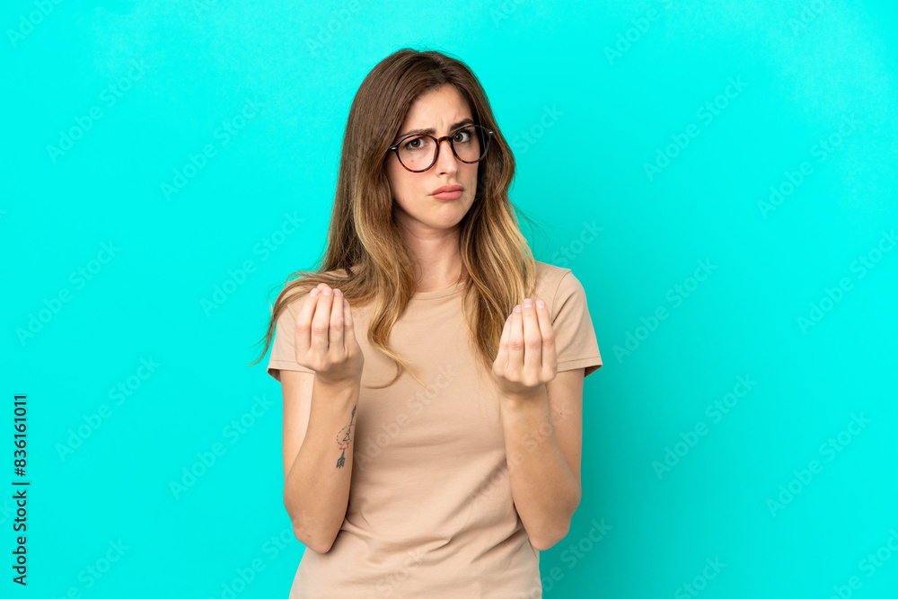 Young caucasian woman isolated on blue background making money gesture but is ruined Young caucasian woman isolated on blue background making money gesture but is ruined