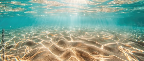 Abstract background of transparent water with ripples and sand at the bottom, top view