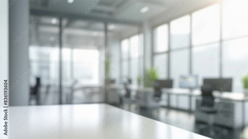 Empty desk in modern office space. Blurred office interior with empty desk in foreground, perfect for product placement or business concept. Empty desk in modern office space. Blurred office interior with empty desk in foreground, perfect for product placement or business concept.