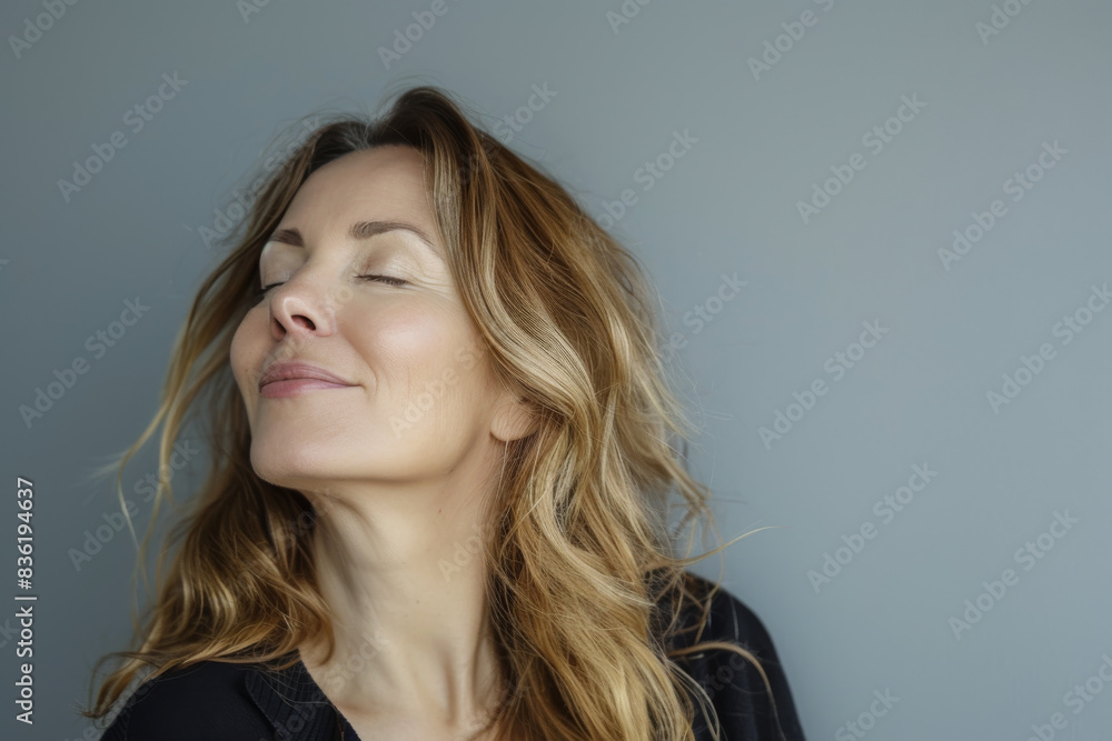 Fototapeta premium A close up of a woman's face with her eyes closed looking to a side