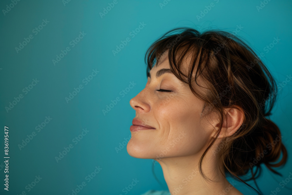 A close up of a woman's face with her eyes closed looking to a side A close up of a woman's face with her eyes closed looking to a side