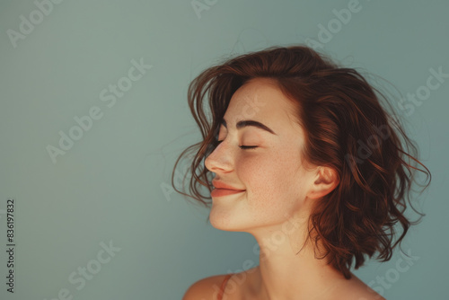 A close up of a woman's face with her eyes closed looking to a side