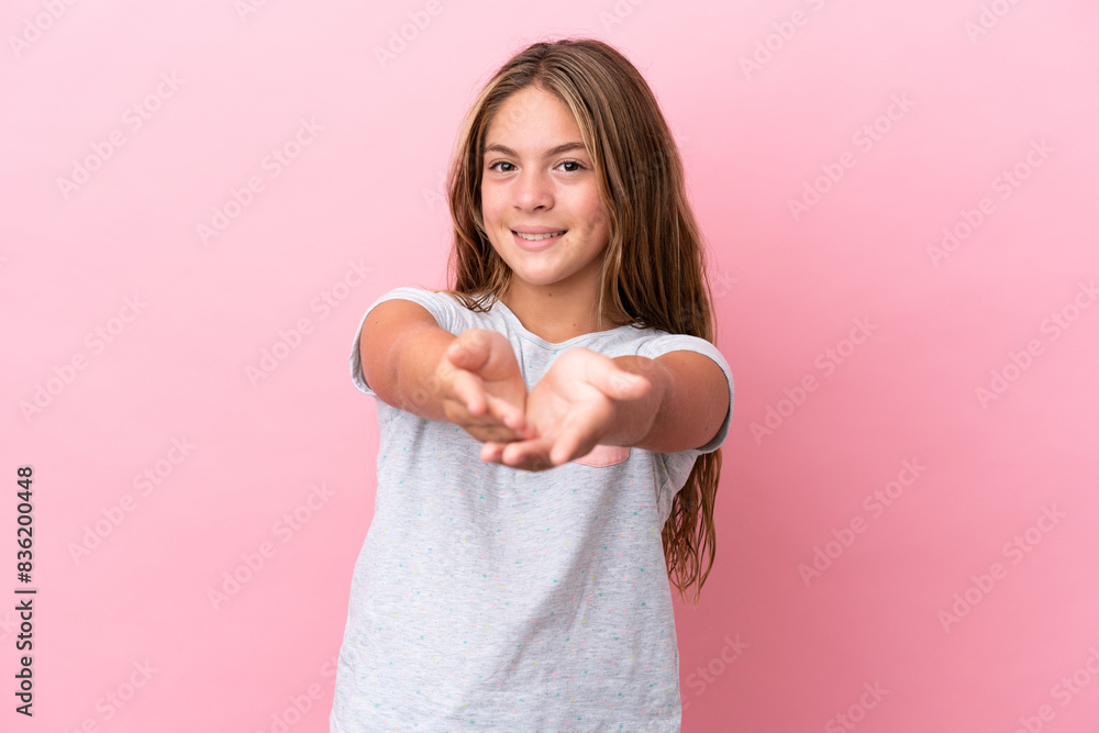 Little caucasian girl isolated on pink background holding copyspace imaginary on the palm to insert an ad Little caucasian girl isolated on pink background holding copyspace imaginary on the palm to insert an ad
