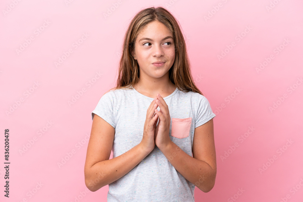 Little caucasian girl isolated on pink background scheming something Little caucasian girl isolated on pink background scheming something