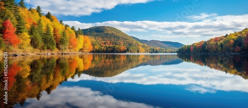Autumn landscape with a lake mirroring the sky, creating a tranquil scene with copy space image.
