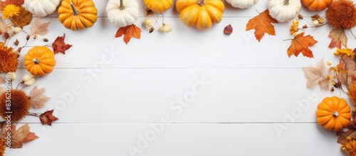 Fall-themed arrangement featuring dried leaves  pumpkins  flowers  and rowan berries on a white backdrop with space for text or images. Perfect for autumn  Halloween  or Thanksgiving concepts