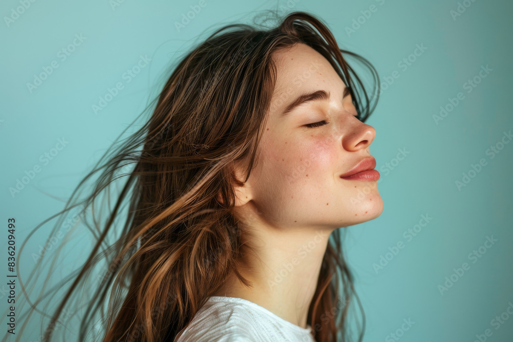 A close up of a woman's face with her eyes closed looking to a side A close up of a woman's face with her eyes closed looking to a side