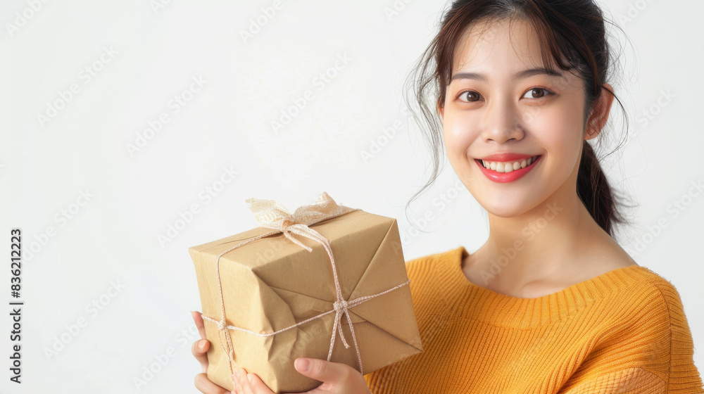 adorable Asian female person hold giftbox near head guessing what inside adorable Asian female person hold giftbox near head guessing what inside
