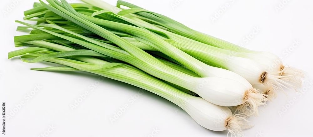 Top-down view of a wooden bowl with green onions on a white backdrop, ideal for copy space image. Top-down view of a wooden bowl with green onions on a white backdrop, ideal for copy space image.