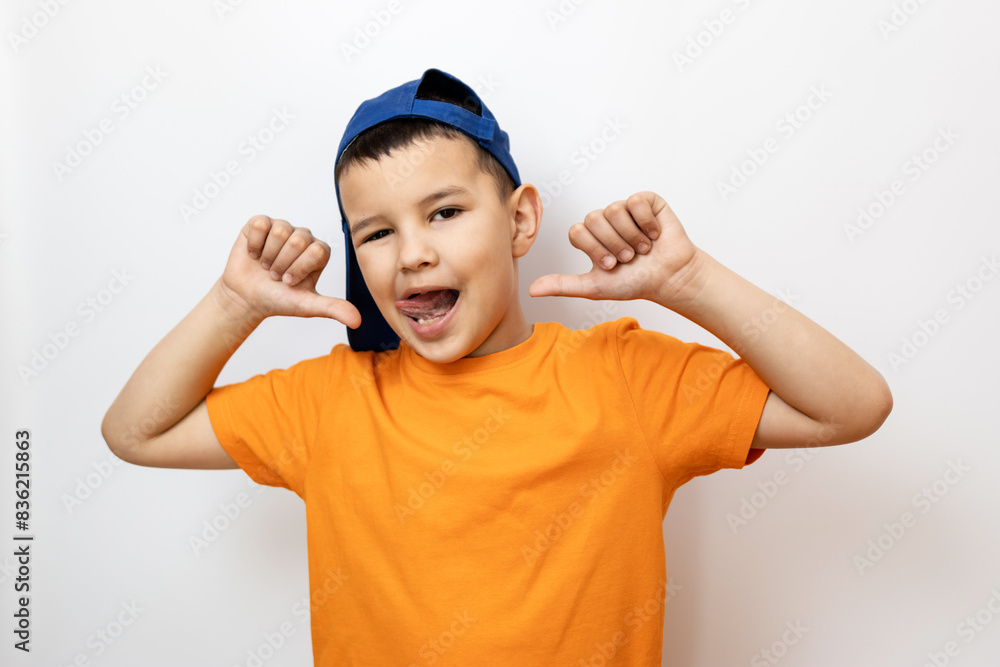 The guy raised his hands to his ears, shows a funny face. Sincere children's emotions. The guy raised his hands to his ears, shows a funny face. Sincere children's emotions.
