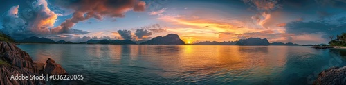 panoramic view of colorful sunset over the sea with mountains