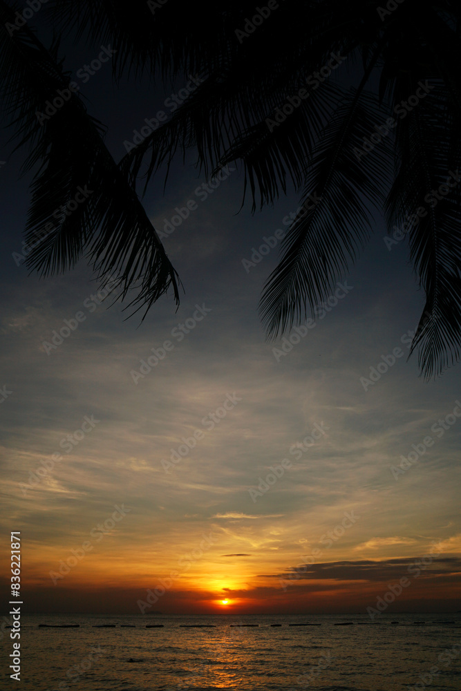 Landscape Tranquil scene of big red sun and orange sky sunset over the sea and silhouette tree at pattaya Thailand. Landscape Tranquil scene of big red sun and orange sky sunset over the sea and silhouette tree at pattaya Thailand.