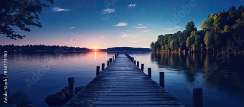 Fototapeta Naklejka Na Ścianę i Meble -  Viewing a serene Wisconsin lake from the end of a pier at dusk with copy space image.