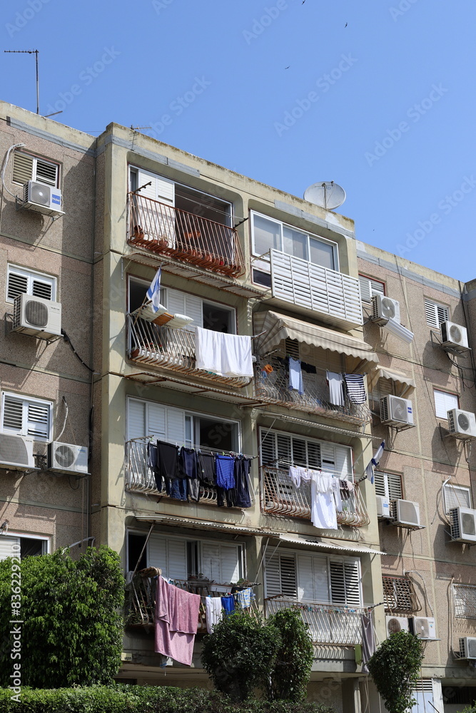 Washed laundry hangs on a rope outside the window. Washed laundry hangs on a rope outside the window.