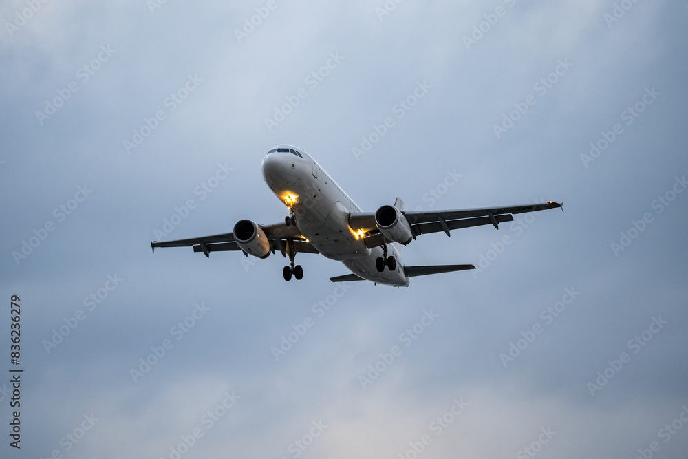 Airplane registration flying on cloudy day, approaching landing in Tan Son Nhat Airport in Vietnam Airplane registration flying on cloudy day, approaching landing in Tan Son Nhat Airport in Vietnam