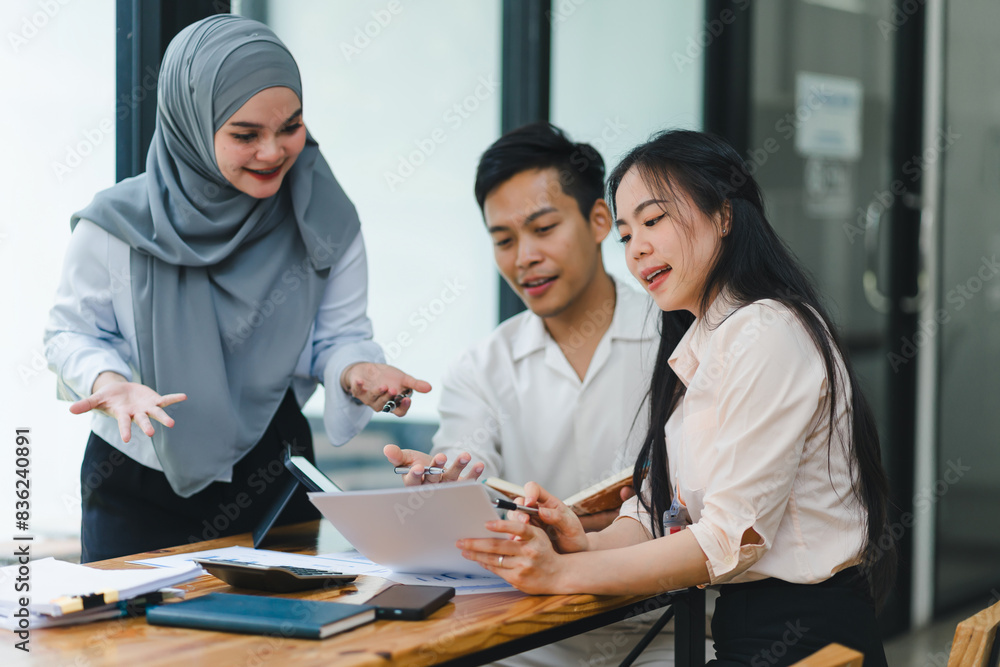 Businesswoman leading a team meeting in an office. Businesswoman leading a team meeting in an office.