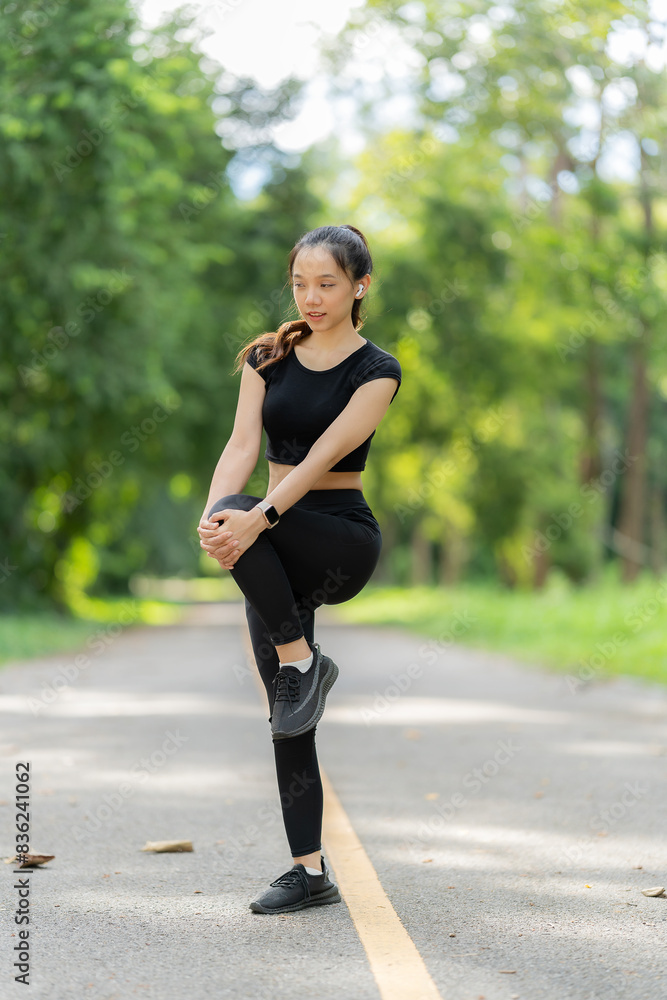 Healthy woman warms up before jogging and relaxes. Stretch your arms and look outside at the road, get in shape at the park before running and enjoy healthy outdoor activities. Healthy woman warms up before jogging and relaxes. Stretch your arms and look outside at the road, get in shape at the park before running and enjoy healthy outdoor activities.