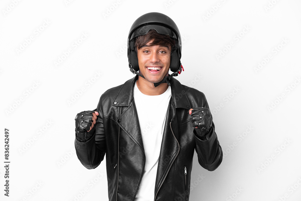 Young man with a motorcycle helmet isolated on white background celebrating a victory in winner position Young man with a motorcycle helmet isolated on white background celebrating a victory in winner position