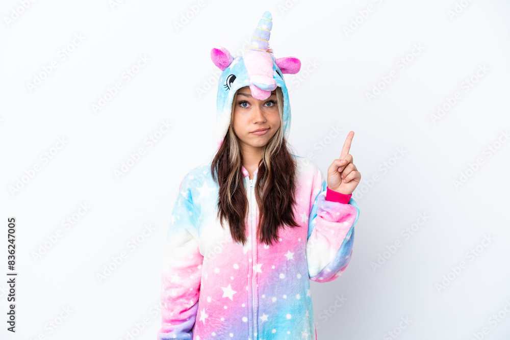 Young Russian woman wearing a unicorn pajama isolated on white background pointing with the index finger a great idea Young Russian woman wearing a unicorn pajama isolated on white background pointing with the index finger a great idea