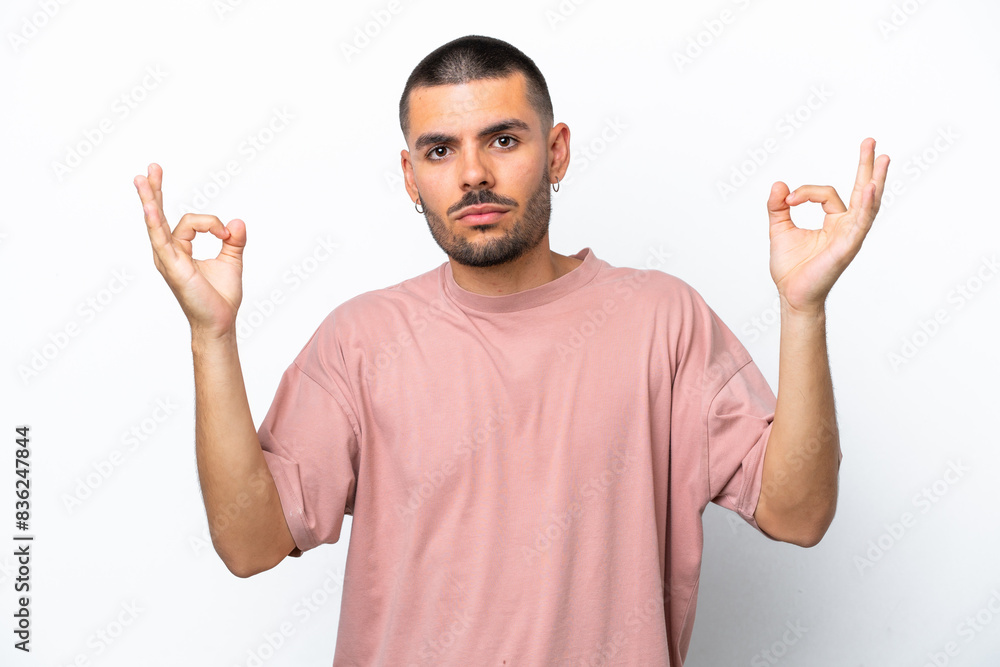 Young caucasian man isolated on white background in zen pose Young caucasian man isolated on white background in zen pose