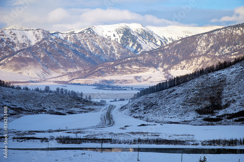 Cold snowy mountain landscape at sunset.