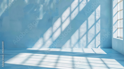 Minimal light blue background  shadow play from windows on a plaster wall for product presentation