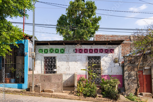 Street view with colorful painted of houses with trellis covered windows in the center of Juilgalpa capital city Chontales Department of Nicaragua photo