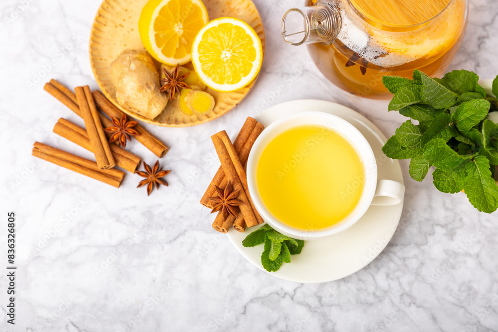 Fragrant hot tea with cinnamon stick and anise on a textured wooden background. A cup of hot tea with honey, lemon, mint and apples. Spicy tea with spices. Immunity tea. Health concept.Copy space. Fragrant hot tea with cinnamon stick and anise on a textured wooden background. A cup of hot tea with honey, lemon, mint and apples. Spicy tea with spices. Immunity tea. Health concept.Copy space.