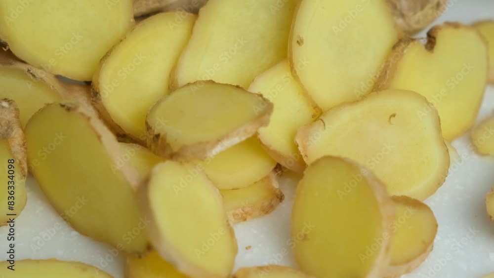 Slices of fresh ginger root falling, slow motion. Slices of fresh ginger root falling, slow motion.