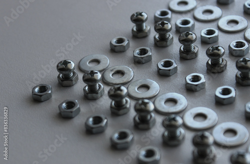 Metal Steel Fastener And Fixing Parts In Even Lines On Plastic Surface Detailed Stock Photo. Ironware Goods Royalty Free Background © AnyVIDStudio