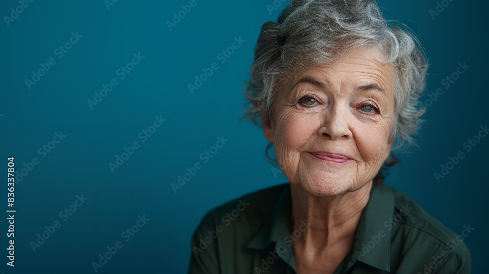 Closeup portrait, headshot happy, smiling, laughing, senior old woman, grandmother, isolated blue background. Positive human emotions, facial expressions, life perception, feelings, attitude, reaction Closeup portrait, headshot happy, smiling, laughing, senior old woman, grandmother, isolated blue background. Positive human emotions, facial expressions, life perception, feelings, attitude, reaction