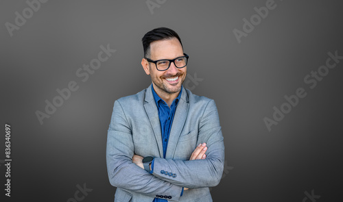 Фотография Portrait of entrepreneur with arms crossed smiling and looking away thoughtfully