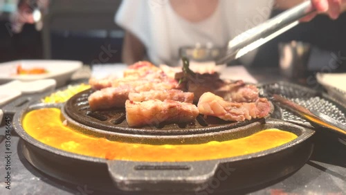 people cook the delicious barbecue pork in korean bbq 