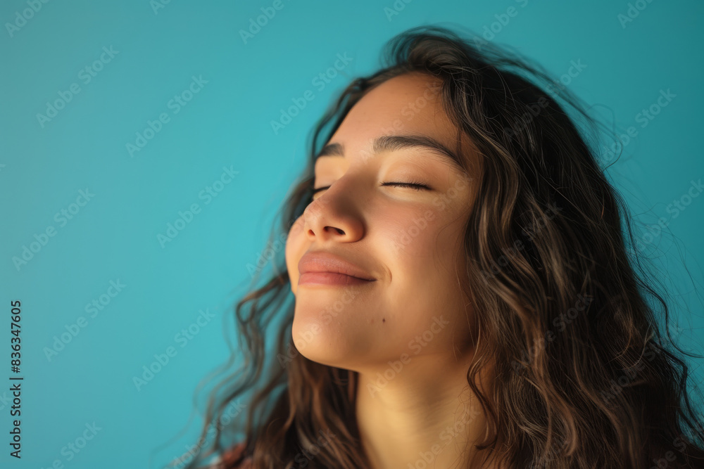 Fototapeta premium A close up of a woman's face with her eyes closed looking to a side