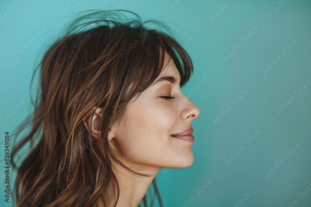 A close up of a woman's face with her eyes closed looking to a side A close up of a woman's face with her eyes closed looking to a side