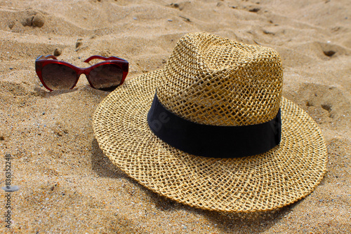 straw hat and sunglasses on the beach