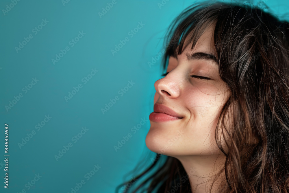 A close up of a woman's face with her eyes closed looking to a side A close up of a woman's face with her eyes closed looking to a side