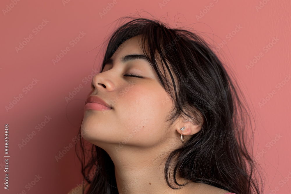 A close up of a woman's face with her eyes closed looking to a side A close up of a woman's face with her eyes closed looking to a side