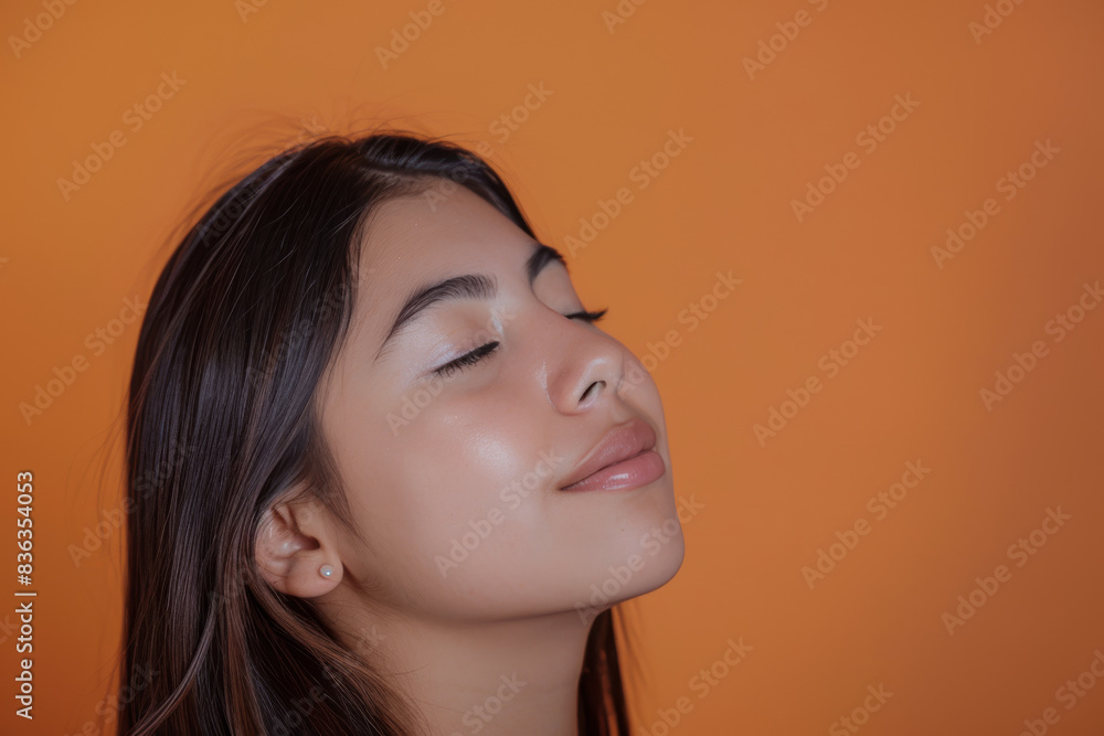 Fototapeta premium A close up of a woman's face with her eyes closed looking to a side