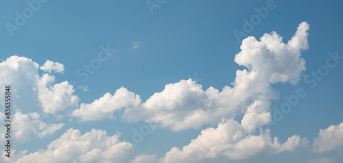 Cumulus humilis (cumuliform) clouds on the bright blue sky on a sunny day photo