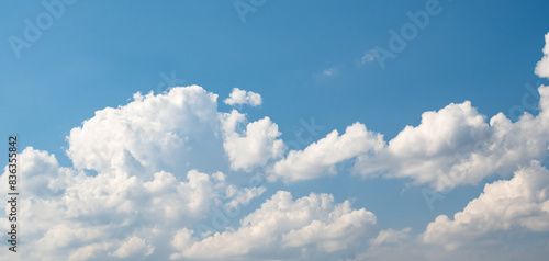 Cumulus humilis (cumuliform) clouds on the bright blue sky on a sunny day photo
