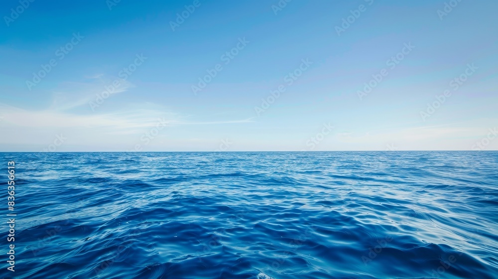 Obraz premium Tranquil Seascape with Clear Blue Sky - Peaceful Ocean Waves Background with Copyspace, Serenity and Calmness