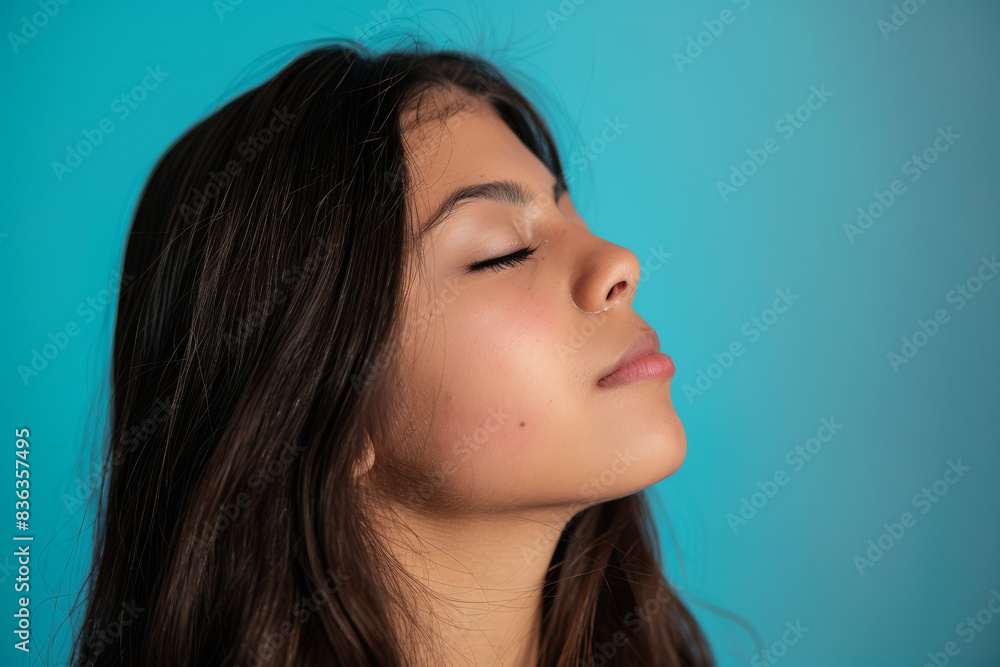 A close up of a woman's face with her eyes closed looking to a side A close up of a woman's face with her eyes closed looking to a side