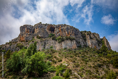 Mountainous landscape with rocky crag with caves near Benízar, in Moratalla, Region of Murcia, Spain in summer