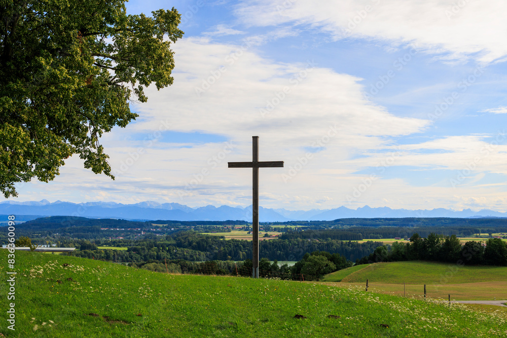 Alpine view over meadows and field paths towards the Alps near Reichling in Bavaria on a summer day with blue sky and light clouds Alpine view over meadows and field paths towards the Alps near Reichling in Bavaria on a summer day with blue sky and light clouds