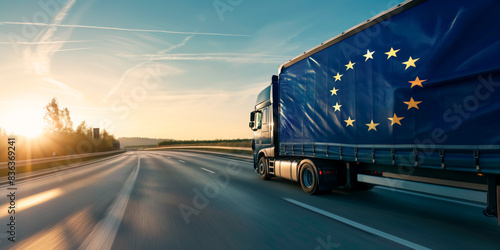 Truck with European Union flag on highway. Concept of international transportation, European pride, logistics, road transport, global trade