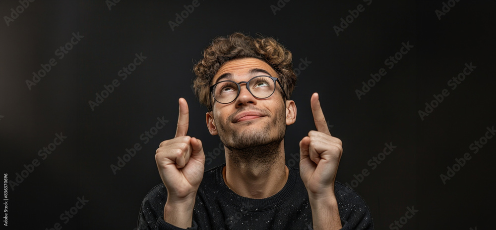 Close-up portrait of a young, funny guy making hand gestures that express hope for the best, wishing for a miracle. His playful expression conveys optimism and a light-hearted spirit Close-up portrait of a young, funny guy making hand gestures that express hope for the best, wishing for a miracle. His playful expression conveys optimism and a light-hearted spirit