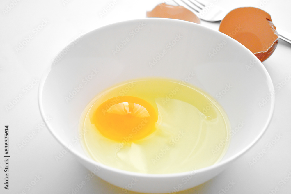 Egg yolk in a white bowl. Cooking preparation concept. Egg yolk in a white bowl. Cooking preparation concept.